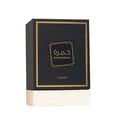 Lattafa Khamrah — Black perfume box with gold geometric frame and Arabic script, Lattafa logo below, on a textured white base.