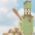 Lattafa Eclaire Pistache — Green perfume bottle with gold dripping accents against a blurred sky and pistachio background