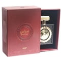 Lattafa Pride Nebras — Red textured box with sunburst design, opening to reveal a black perfume bottle with a gold cap and ornate gold atomizer.