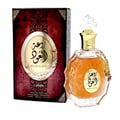 Lattafa Rouat Al Oud by Lattafa 100ml EDP Unisex — A maroon and gold patterned box sits next to a clear glass perfume bottle with amber liquid and a gold cap, featuring ornate detailing and a hanging charm.