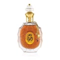 Lattafa Rouat Al Oud by Lattafa 100ml EDP Unisex — Clear glass perfume bottle with ornate gold detailing and Arabic script, featuring a gold chain with a clover charm and a dark red gem.