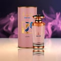 Lattafa Mayar by Lattafa EDP 100ml Woman — Pink cylindrical box and a pink glass perfume bottle with gold accents, set against a blurred purple and pink smoky background.