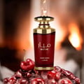 Lattafa Mayar Cherry Intense Lattafa 100ml EDP — A deep red perfume bottle with gold accents, surrounded by fresh cherries and ice, with a warm, blurred background resembling a fireplace.