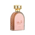 Lattafa Shahd — A clear glass perfume bottle with a pink label, featuring Arabic script and 'SHAHd' and 'Lattafa' in English. The bottle has a decorative pattern of branches and leaves on the left side and a gold cap.