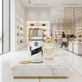 Lattafa Musk Mood by Lattafa 100ml EDP Unisex — Tall cylindrical gift box with gold chain and a perfume bottle with gold cap, displayed on a marble surface in a luxury store.