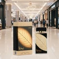 Lattafa Najdia in Gold by Lattafa 100ml Unisex — A perfume box and bottle with a gold leaf design, displayed in a shopping mall.