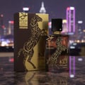 Lattafa Oud Lail Maleki by Lattafa 100 ml Unisex — A brown and gold perfume box and bottle with a horse design, set against a blurred city skyline at night.