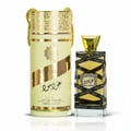 Lattafa Oud Mood Lattafa Arabian 100ml EDP — Cylindrical gold and cream gift box with ornate patterns and a gold drawstring, next to a clear glass perfume bottle with a gold cap, wrapped in black ribbon with repeated 'Oud Mood' text.