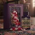 Lattafa Badee Al Oud Amethyst — Purple box with floral design and gold accents next to a purple perfume bottle on a
