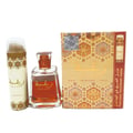 Lattafa Raghba by Lattafa 100ml EDP Unisex — A perfume bottle, a deodorant spray, and a perfume box are arranged together. The perfume bottle is clear glass with orange liquid and a gold cap. The deodorant spray is white with gold accents. The box is gold with intricate patterns and features a smaller image of the