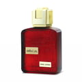 Lattafa Ramz Gold Lattafa Woman 100ml EDP — Red glass perfume bottle with embossed text like 'TOGETHER', 'LOVE', 'HOT', and 'COOL', featuring a gold cap and a gold label with Arabic text and 'RAMZ LATTAFA'.