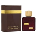 Lattafa Ramz Gold Lattafa Woman 100ml EDP — Brown box with gold text and fingerprint design next to a dark red perfume bottle with gold cap and embossed text.