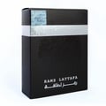 Lattafa Ramz Silver by Lattafa 100ml EDP untuk Lelaki — Kotak minyak wangi hitam dengan rekaan cap jari dan jalur perak bertulis.