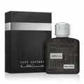 Lattafa Ramz Silver by Lattafa 100ml EDP untuk Lelaki — Kotak hitam bertekstur dengan reka bentuk cap jari bersebelahan botol minyak wangi hitam bertutup perak dengan teks timbul.