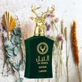 Lattafa Safeer by Lattafa Al Noble 100ml EDP — Green velvet bottle with a gold deer head cap, surrounded by dried flowers and eucalyptus leaves.