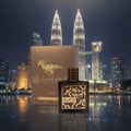 Lattafa Qaed Al Fursan Untamed Lattafa 90ml EDP — A perfume bottle and its box are displayed in front of the Petronas Twin Towers at night, with reflections on the wet floor.