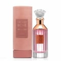 Lattafa Velvet Rose by Lattafa 100ml Unisex — Pink velvet cylindrical box and a clear glass perfume bottle with pink liquid and rose gold accents, set against a white background.