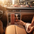 Lattafa Velvet Rose by Lattafa 100ml Unisex — Perfume bottle and its cylindrical box placed on a car's center console, with a woman's hand reaching for the bottle.