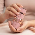 Lattafa Yara Elixir by Lattafa 100ml EDP — Botol minyak wangi merah jambu dengan perincian emas ros dan tulisan Arab, dipegang oleh tangan berserta kuku yang terjaga.