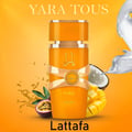 Lattafa Yara Tous by Lattafa 100ml EDP Women — Orange perfume bottle with gold accents, ribbon detail, and Arabic script, surrounded by passion fruit, mango cubes, coconut, and splashing liquid against a vibrant orange background.