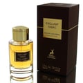 Maison Alhambra Exclusif Tabac – Glass perfume bottle with gold cap and amber liquid, next to a dark brown box with gold text and deer logo.