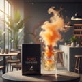 Maison Alhambra Toro Pour Homme – Black box and clear glass bottle with orange smoke emanating from the cap, set on a table in a cafe-like setting.