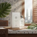 Maison Alhambra Delilah Blanc by Maison Alhambra 100ml EDP — White perfume bottle and box on a terrazzo surface, with a large monstera leaf and a blurred city skyline view through a window.