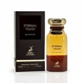 Maison Alhambra Eternal Touch Eau de Parfum — A brown textured box with gold lettering and a deer logo stands next to a clear glass perfume bottle with gold accents and a brown ombre effect.