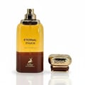 Maison Alhambra Eternal Touch by Maison Alhambra 80ml EDP — A two-toned bottle of amber and brown perfume with a gold cap and a separate gold cap shown next to it, against a white background.