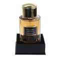 Maison Alhambra Exclusif Saffron by Maison Alhambra – Amber liquid in a clear glass bottle with a gold cap, presented on a black square stand.
