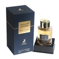Maison Alhambra Exclusif Saffron — Navy blue box with gold accents and a clear glass perfume bottle with gold cap and amber liquid, presented on a black stand.