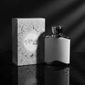 Maison Alhambra Expose Blanc by Maison Alhambra 100ml EDP Men — White perfume bottle with silver accents next to its patterned box, on a reflective surface with water droplets.