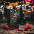 Maison Alhambra Extravagant Lover by Maison Alhambra – 100 ml perfume bottle and box on a wooden surface with strawberries, blueberries, and rose petals, blurred market lights in background