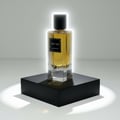 Maison Alhambra The Tux by Maison Alhambra 90ml EDP for Men — A clear glass perfume bottle with golden liquid, black cap, and a black label reading 'THE TUX EAU DE PARFUM', displayed on a black square pedestal with a white glowing halo effect around the bottle.
