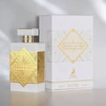 Maison Alhambra Infini Musk — White perfume bottle with gold geometric accents and a matching white box with gold geometric design, set against a neutral background.