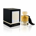 Maison Alhambra Karat by Maison Alhambra 100ml EDP — Black gift box with gold ornate design and the Karat perfume bottle with gold cap and black tassel, set against a white background with reflections.