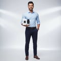 Maison Alhambra Dark Door Sport Men 100ml EDP — Man in light blue shirt and navy pants holding a white perfume box and a black perfume bottle, smiling against a white background with spotlight effect.