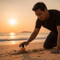 Maison Alhambra Terra by Maison Alhambra – 50 ml Unisex bottle on a sandy beach at sunset, man kneeling beside it