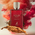 Maison Alhambra Tobacco Your Touch — Red glass perfume bottle with a gold ribbed cap, surrounded by red and orange smoke plumes, with a dried tobacco leaf in the foreground and loose tobacco leaves scattered around.