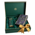 Maison Alhambra Sceptre Malachite — Green gift box with gold trim, open to reveal a green perfume bottle with gold accents, a matching patterned box, and a gold ribbon tied in a bow.