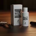 Maison Alhambra No.2 Men by Maison Alhambra 80ml EDP — White perfume bottle and box with black text, a watch, and a wallet on a wooden surface.