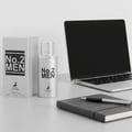 Maison Alhambra No.2 Men by Maison Alhambra 80ml EDP — Silver perfume bottle and box next to a laptop and notebook with a pen.
