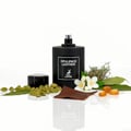 Maison Alhambra Opulence Leather — Black perfume bottle with cap beside it, surrounded by cardamom pods, jasmine flowers, bay leaves, amber resin, and a piece of leather.