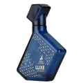 Maison Alhambra Luxe Journey — Blue glass perfume bottle with geometric white pattern and a deer logo, angled view