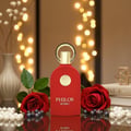 Maison Alhambra Philos Rosso 100ml EDP — Red bottle with gold accents, two red roses, pearls, and bokeh lights in the background.