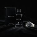 Maison Alhambra Salvo by Maison Alhambra For Him 100ml — Black perfume bottle and box with a silver and gold watch on a dark fabric background