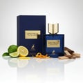 Maison Alhambra Spectrum by Maison Alhambra 100ml EDP Men — Blue glass perfume bottle with gold cap, navy box, citrus slices, orange peel, and wood chips on a reflective surface.