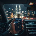 Maison Alhambra True Word by Maison Alhambra 100ml EDP — Hand holding a blue glass perfume bottle with a gold cap inside a car at night, with city skyscrapers in the background.