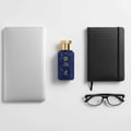 Maison Alhambra True Word by Maison Alhambra 100ml EDP — Blue perfume bottle with gold cap, laptop, black notebook, and glasses on a white background.