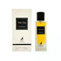 Maison Alhambra The Tux — A white textured box with black text and a deer logo stands next to a clear glass perfume bottle with yellow liquid and a black cap.